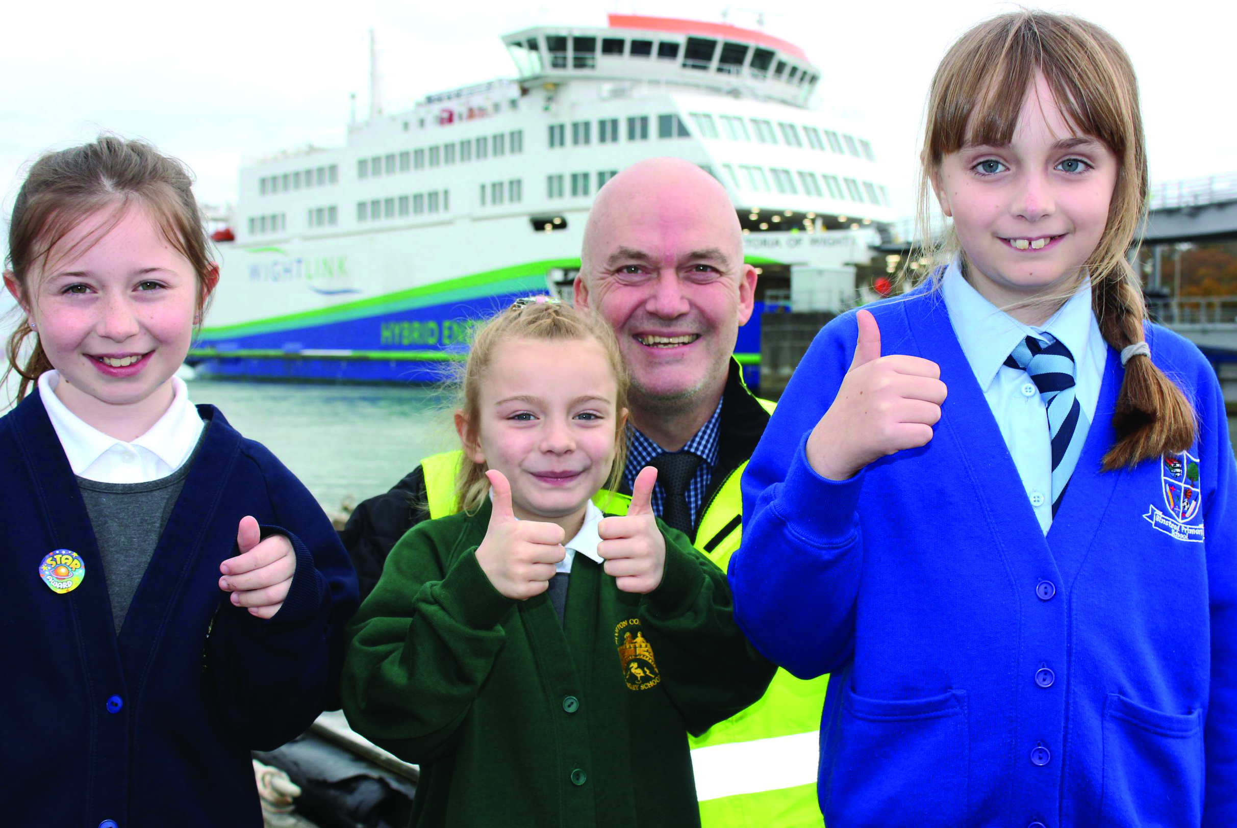 Image:Local schoolchildren Kezia Sheath, Ayra Quayle and Lisa Saunders meet Wightlink's island port operations manager Martin Gulliver at Fishbourne terminal  Image: Wightlink