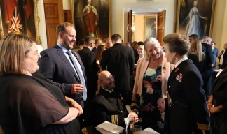 Image: HRH, The Princess Royal chats to Captain Mooney and his family at the reception.