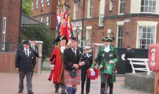 Image:The piper Dale McLean leads the Parade of Standards onto the pier with the Lord Mayor and Admiral of the Humber. Also in attendance were other dignitaries, and  local representatives of the Merchant Navy, Royal Navy and fishing fleets.