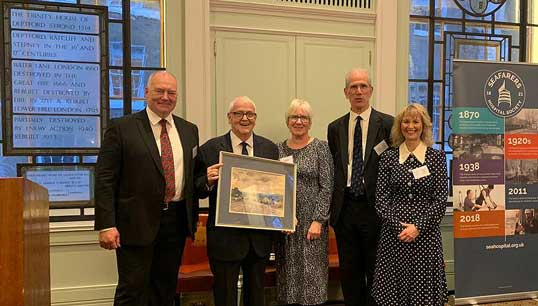 Image:Former deputy general secretary of Nautilus International Peter McEwen holds a watercolour painting gifted to him at a drinks reception hosted by Trinity House for the SHS bicentennial celebrations. Beside him at left is incoming chair Captain Kuba Szymanski.  The others are from left: Carole McEwen (Mr McEwen's wife), Sandy Nairne (deputy chair), Sandra Welch (CEO). Image: SHS