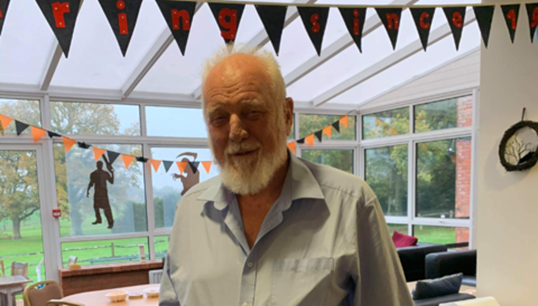 Image:Springbok Estate resident Peter Castle enjoying the low-key residents' bubble celebrations of the Care Ashore centenary