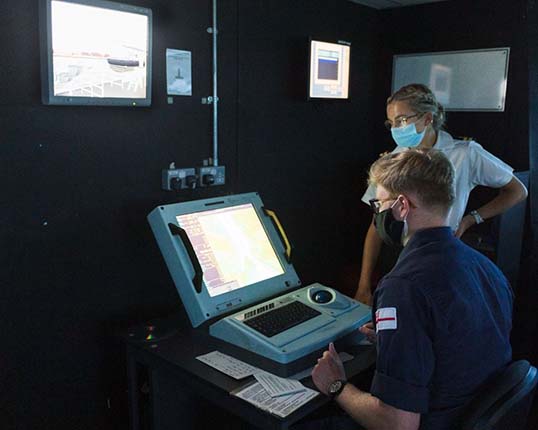 Image:A Merchant Navy Cadet learns how to use the Royal Navy's WECDIS digital navigation system. Image: Royal Navy