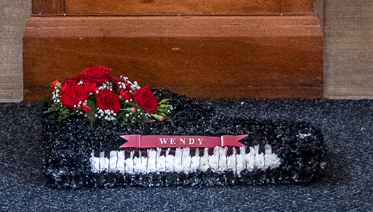 Image:Floral tribute in the shape of Wendy's keyboard: black patent sprayed on white Michaelmas Daisies. Image: Jason Shipley