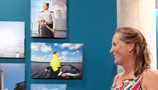Image:Nautilus Council member Captain Jessica Tyson with the pictures of herself and other Nautilus members at work in the She Sees exhibition