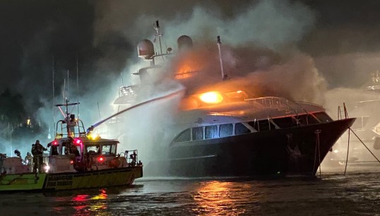 Image:Firefighters attempt to extinguish the blaze aboard the yacht Andiamo, which was caused by two candles and exacerbated by poor maintenance of fire safety equipment. Image: US Coast Guard 