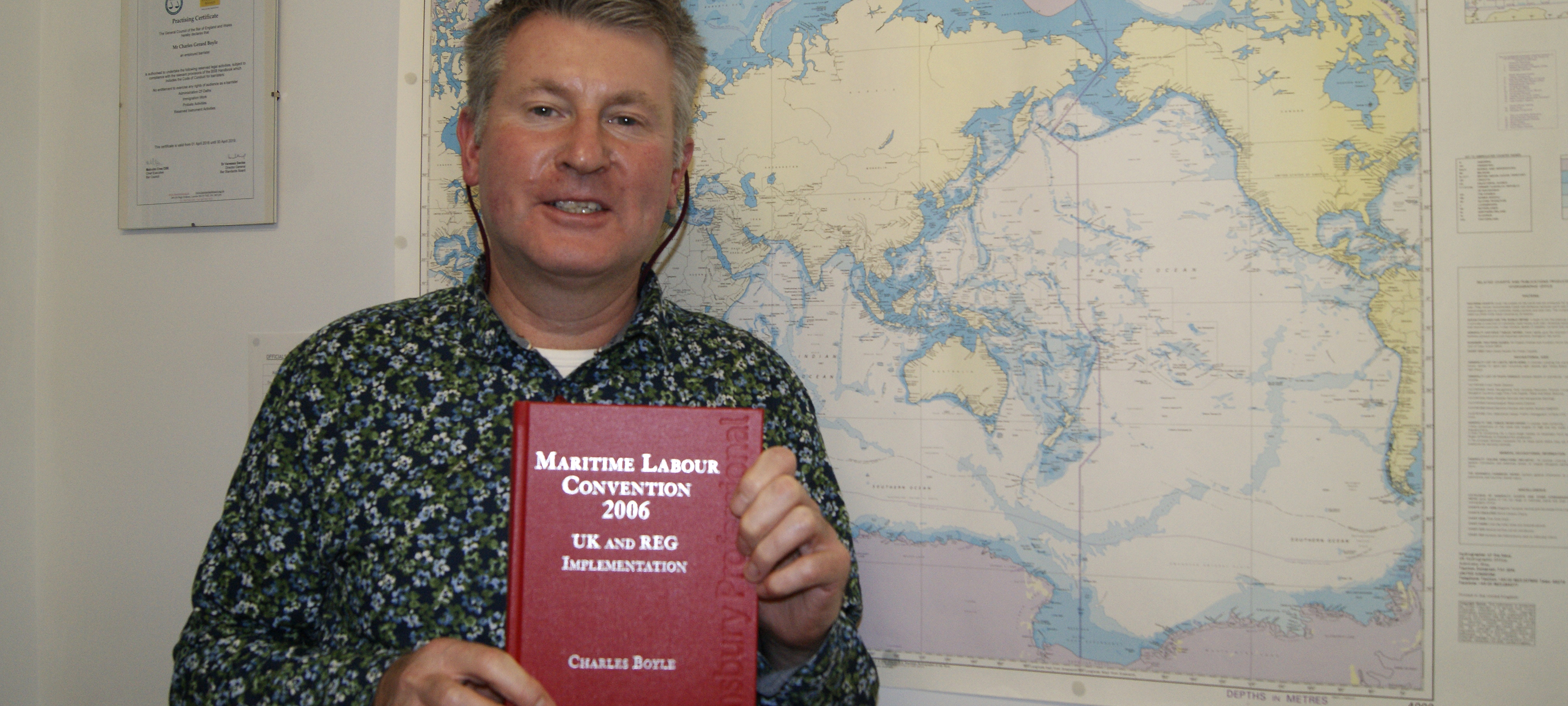 Image:Charles Boyle, director of Nautilus legal services, with a copy of his book on the MLC.