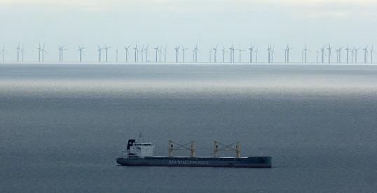 Image:Ship at anchor on the east coast of Anglesey with the massed ranks of Gwynt y Môr offshore wind farm across the bay. Source: Wikimedia Commons