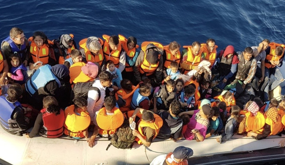 Image:Migrants in a dangerously overcrowded dinghy witnessed by third officer Ross Cleland - including disabled and elderly people and very young children