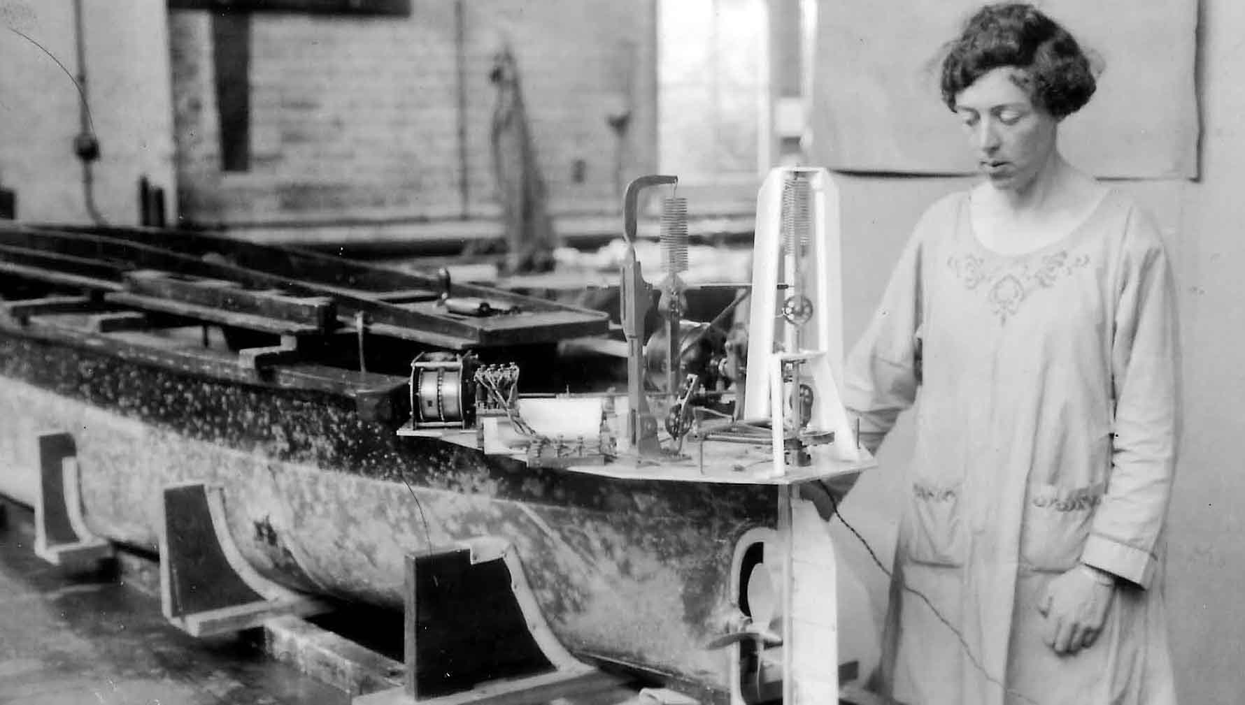 Image:Eily Keary working at Teddington’s National Test Tank helping design a destroyer that could do 39 knots.  Sir Alfred Yarrow, the honorary vicepresident of what was then known as INA, saw her achievement as ‘a very fine recommendation in favour of the ladies joining.’  Image: courtesy of Peter Smith-Keary 