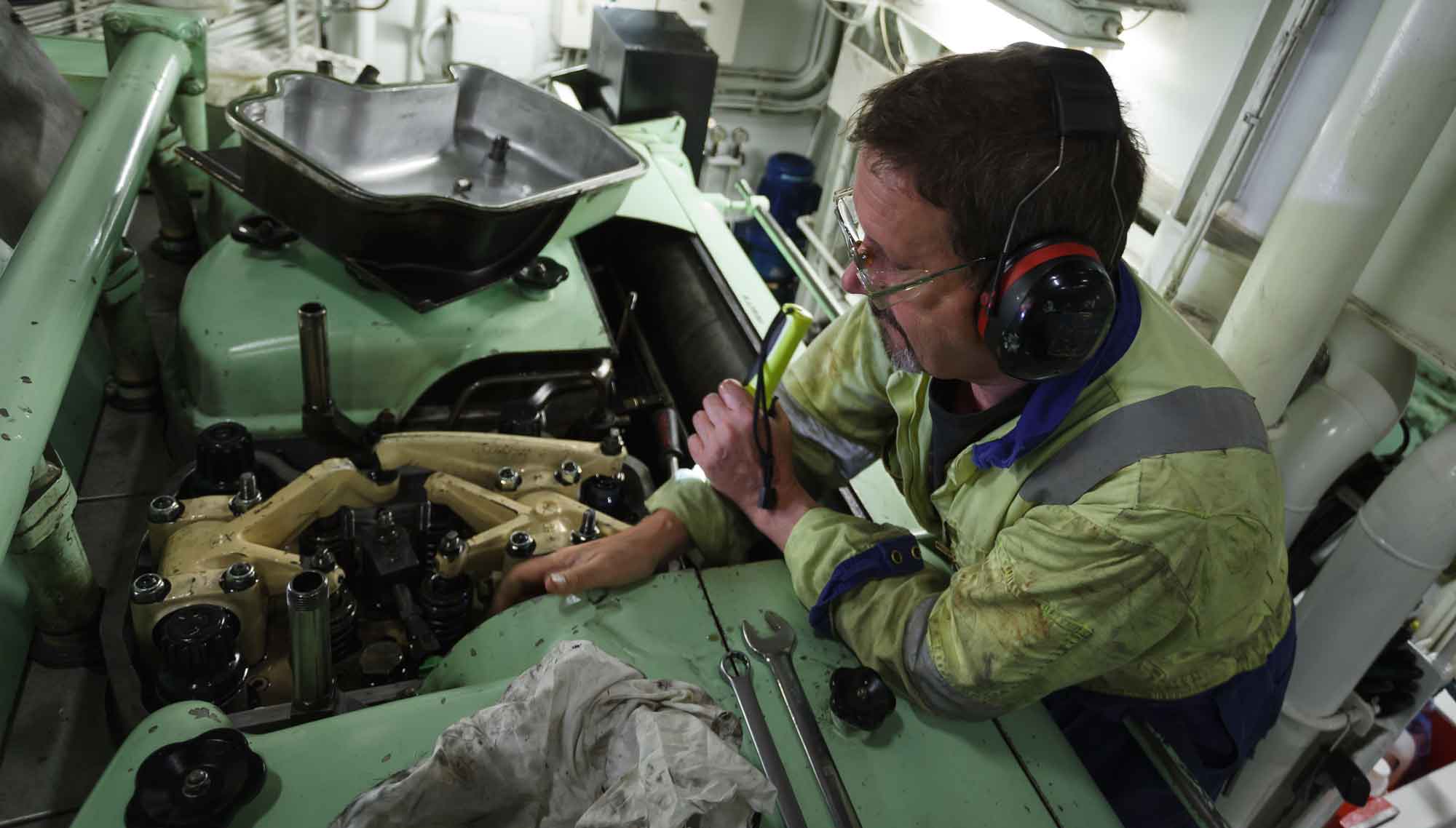 Image:A marine engineer works on a ship's engine. Image: Getty Images.