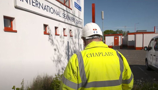 Image:A chaplain approaches an International Seafarers' Centre Image: SIRC film