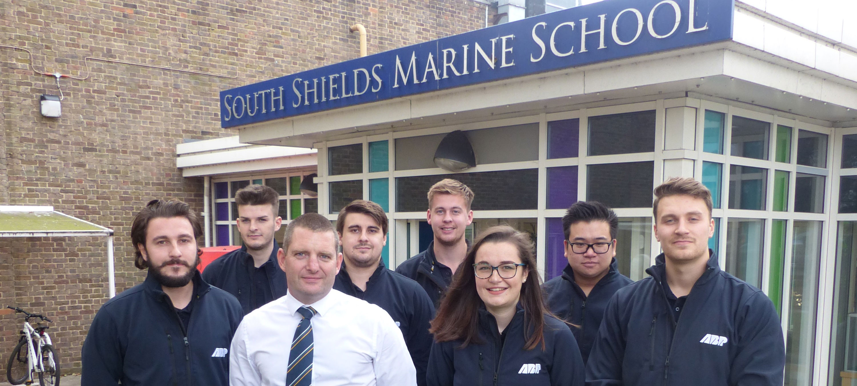 Image:Jon Milner, head of school for deck officer certification, with Associated British Ports (ABP) apprentices Izzy Waterfall, Matt Rattenbury, Gar-Wai Wong, Elliott Jones, Joe Dickinson, Alex Holliday, and Will Parker. They are attending the school for two terms of a new, three-year Port Operations Officer training programme.
