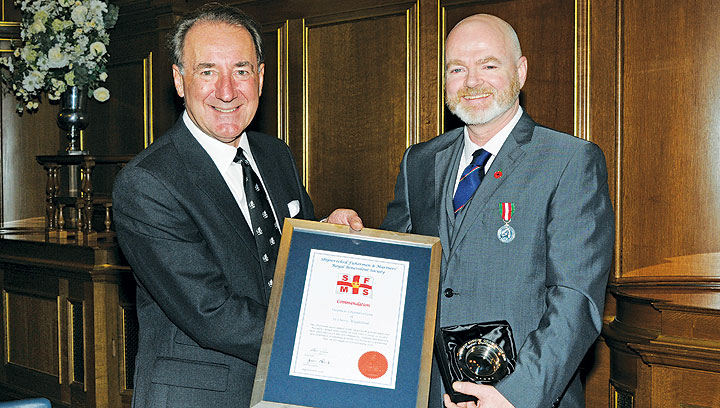 Image:Stephen Chamberlain (right) receiving a Skill and Gallantry Award from Shipwrecked Mariners' Society president Sir George Zambellas