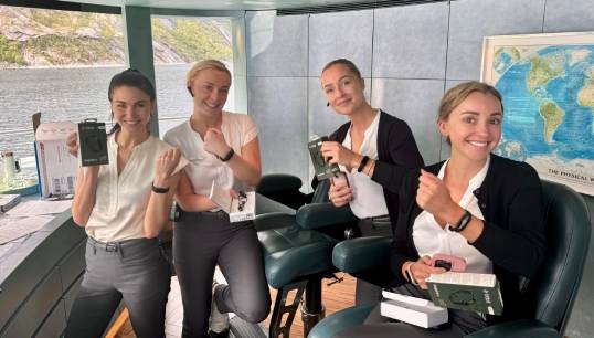 Image:Yacht crew from the Savannah, including Jo De Luca (first left) display the Fitbit wrist watches they have worn throughout the SIM project. Image: SY Savannah