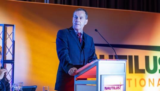 Image:Nautilus head of organising Garry Elliott raising the motion on fire and rehire at the 2023 Nautilus International General Meeting. Image: Brad Wakefield