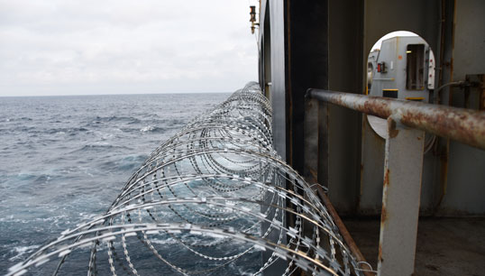 Image:Piracy defence: barbed wire is often attached to a ship hull, superstructure and railings to protect crew against piracy attack in the Gulf of Guinea in West Africa. Image: Getty Images