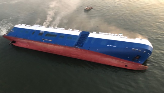 Image:Tugs attempting to stop the Golden Ray sinking in deep water. Image: US Coast Guard