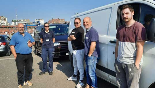 Image:The SeaFit Programme is a joint initiative between Seafarers Hospital Society (SHS) and the Fishermen's Mission and includes face to face UK quayside health events with outreach vans. Pictured is Fishermen's Mission area officer – South East England Ruth Charles (middle)  with some fishermen during a health event. Image: SHS