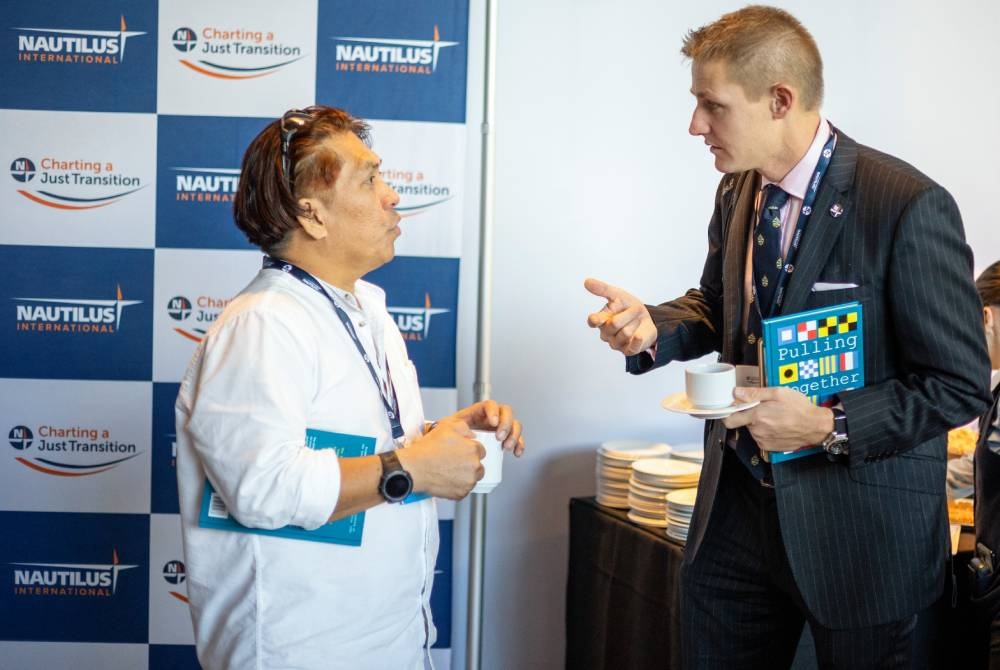 members_with_history_book_pulling_together_NAUTILUS_INTERNATIONAL_LIVERPOOL_2023_DAY_2_083_brad_wakefield_webinsert .jpg