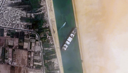 Image:The Ever Given lodged in the Suez Canal. Image: Pierre Markuse/Wikimedia Commons