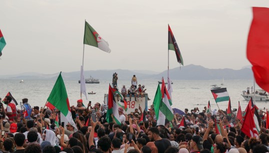 Image:A crowd welcomes elements of the Global Sumud Flotilla to Tunisia, before it was intercepted in international waters. Image: Wikimedia Commons