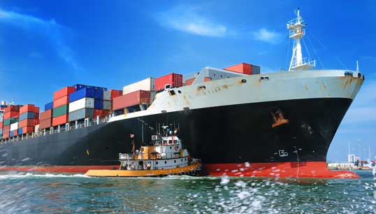 Image:American pilot vessel pushes a container ship into a Seattle seaport. Image: Getty Images