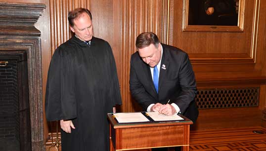 Image:US Secretary of State Mike Pompeo signs his swearing in papers in 2018. Image: Wikimedia Commons