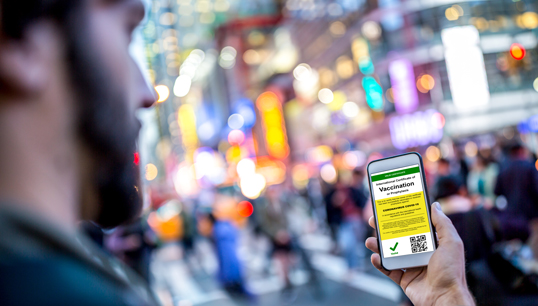 Image:'It is a matter of future industry stability and mariner job security', say six American maritime union presidents. Image: Getty Images - digital certificate of vaccination Times Square.