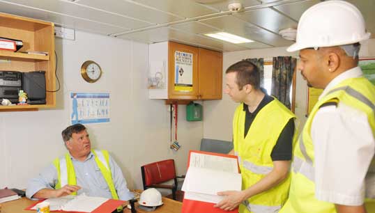 Image:MCA officer and ship inspector checking a ship's compliance with safety standards in the Port of Southampton. Image: Crozet M/ ILO photo library