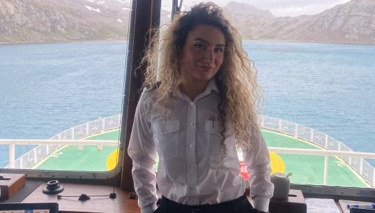 Image:Scarlett Barnett-Smith on the bridge during her time with the British Antarctic Survey. Image: courtesy of Scarlett Barnett-Smith
