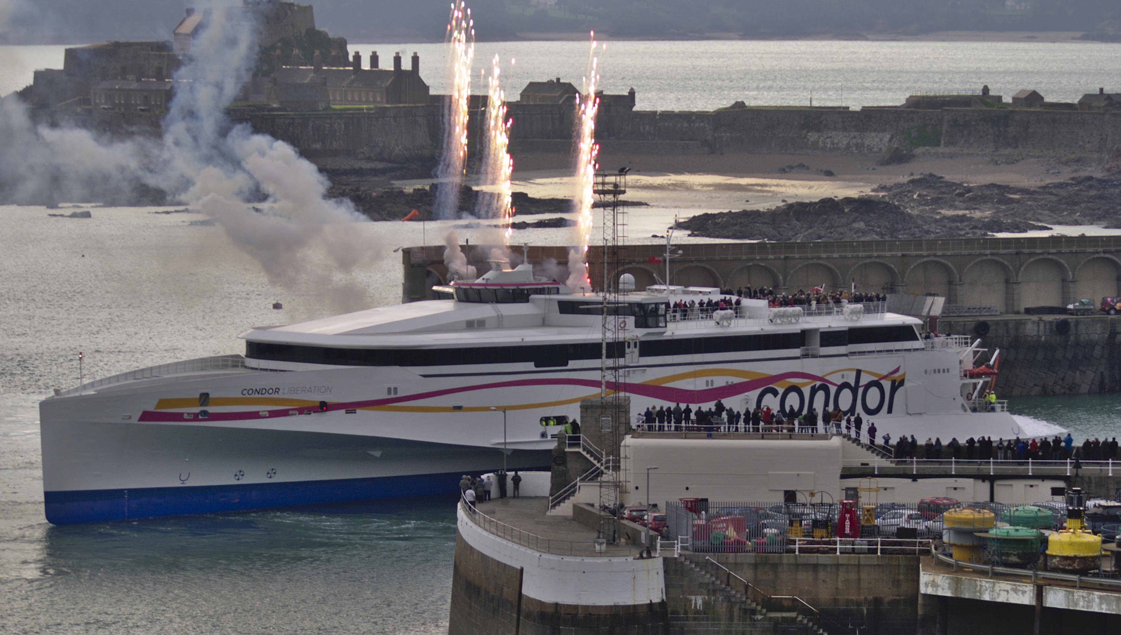 Image:One of the high-speed passenger and car carrying fleet Condor Liberation which sails to the Channel Islands. Image: Tom Brossman captures the vessel entering St Helier Harbour in Jersey, Wikimedia Commons
