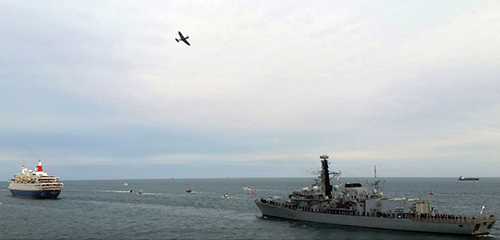 Image: RFA Fort Victoria leads D-Day 75 sail past passenger ship Boudicca in the Solent.