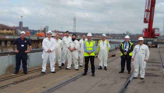 Image:Dave Gatenby (second from right) and Steve Doran (fourth from right) with and members of the Wave Knight crew and members from other RFA ships in Cammel Laird.