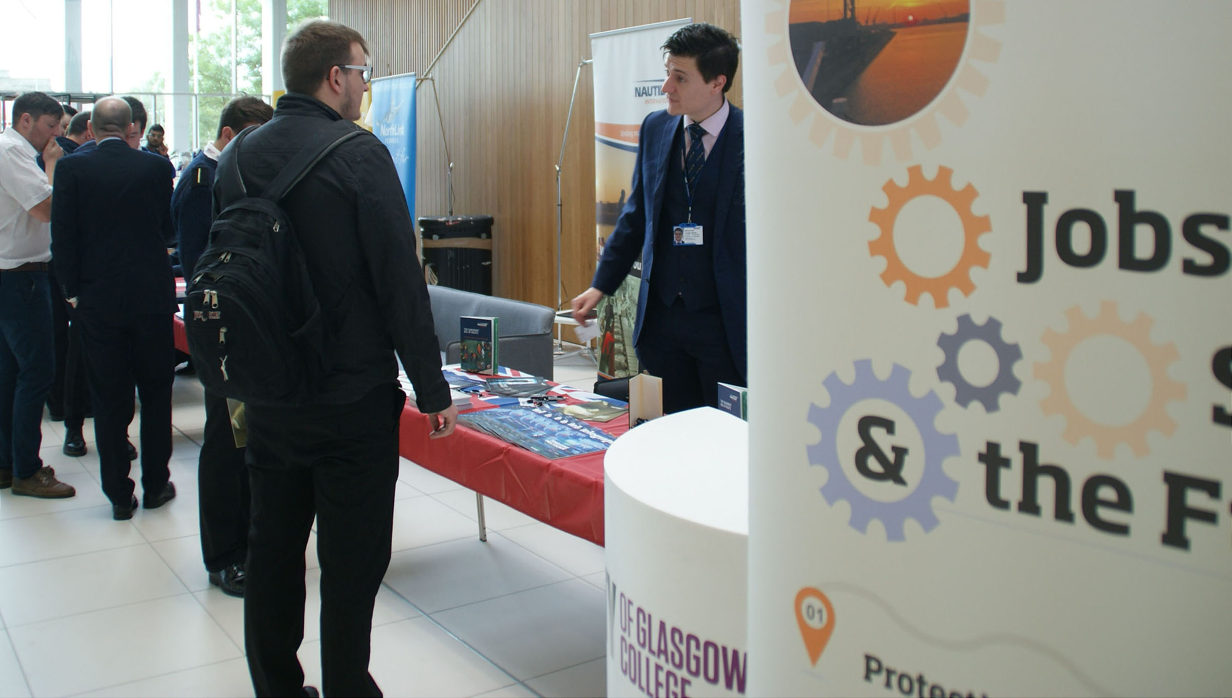 Image:Cadets attending the Union's pilot recruitment event speak to Nautilus strategic organiser Martyn Gray.
