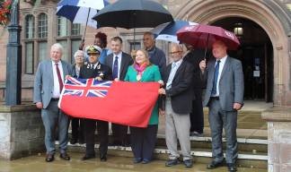 Image:Nautilus member Captain Aseem Hashmi is joined by Coventry's Lord Mayor Rachel Lancaster and other councillors to raise the Red Ensign. Capt Hashmi is master on the RMS Queen Mary 2 cruise ship. Image: Courtesy of Capt Hashmi