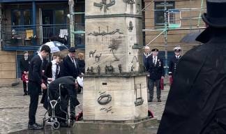 Image:Edinburgh and Forth MNA branch president Captain D Flemming Millar, 96, assisted by Leith Academy students, lays one of the 14 wreaths presented during the well attended Leith remembrance service held at the Scottish National Merchant Navy Memorial . Image: courtesy of A Kautska