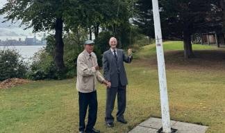 Image:Flag-raising Mariners' Park residents (from left) Gary Dickinson and Alex Harrison.