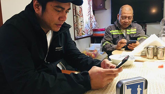 Image:Seafarers enjoying internet access provided by the MiFi project. 