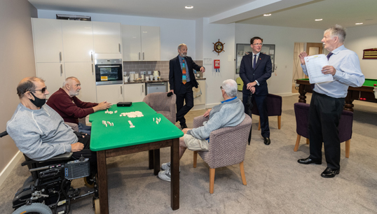 Image:Maritime Minister Robert Courts talks to residents in the games room at Nautilus Mariners' Park during a visit on Day of the Seafarer. Image: Gavin Trafford