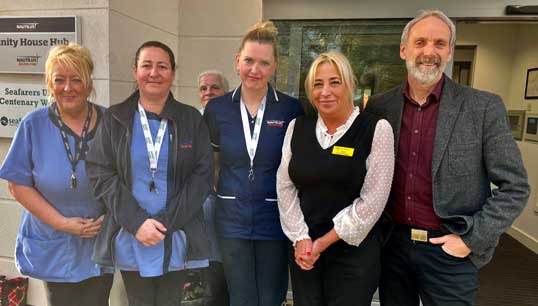 Image:Retiring Nautilus Welfare Fund manager Mick Howarth, right, with some of the staff at Mariners' Park outside the Trinity House Hub. Image: Nautilus Welfare Fund