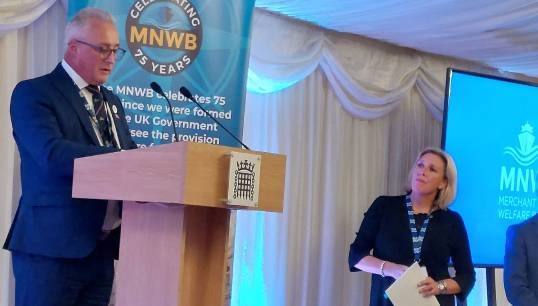 Image:Chief executive of the MNWB Stuart Rivers addresses the charity's 75th anniversary event at Westminster. Watching (right) is maritime minister Baroness Vere of Norbiton. Image: Nautilus International