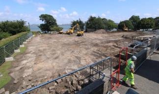 Image:The cleared site with views towards the River Mersey. The hedge visible at left runs beside Manor Lane, used to access the promenade. Image: Time-lapse Manchester