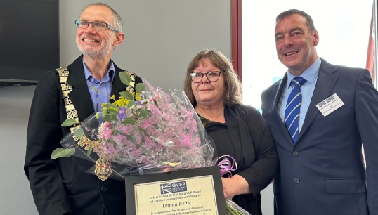 Image:At the reopening ceremony, Donna Betts (middle) received recognition for 26 years of service to seafarer welfare in Felixstowe from QVSR CEO Alex Campbell (right) and the mayor of Felixstowe David Rowe. Image: QVSR

