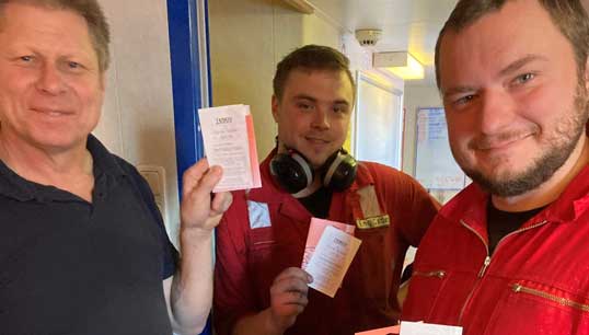 Image:Seafarers with the free phone SIM card top-ups they received from Stella Maris. Image: Stella Maris